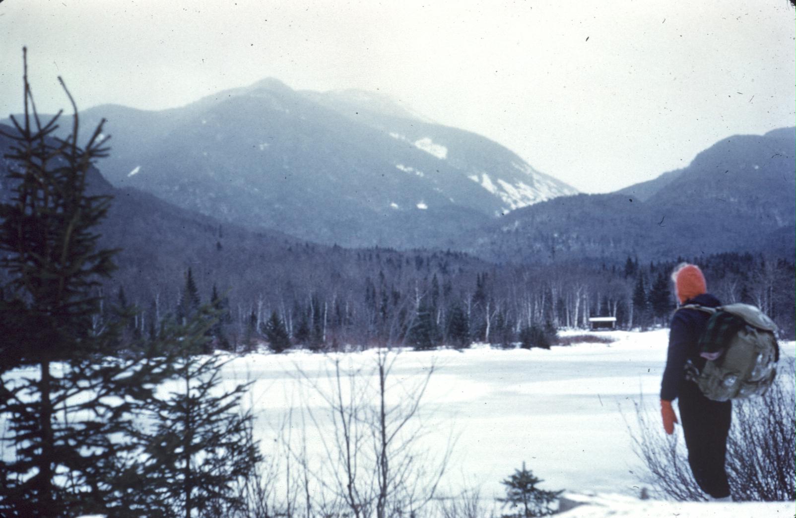 Grandpa’s original photo, a lone hiker with backpack looks across Marcy Dam Pond up at Mount Marcy