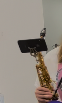 A phone clamped in a lyre on an alto saxophone